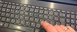 Hand on notebook keyboard